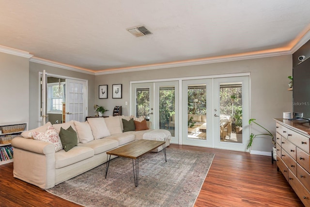 living room with french doors, dark hardwood / wood-style floors, and ornamental molding