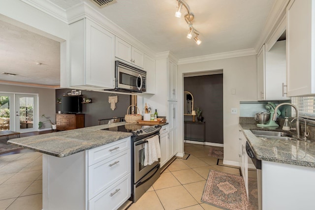 kitchen with stone counters, white cabinetry, sink, and appliances with stainless steel finishes