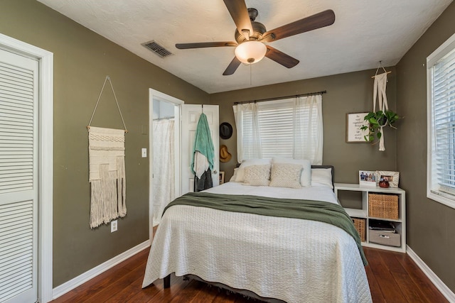 bedroom featuring ceiling fan, dark wood-type flooring, and a closet