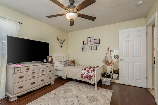 bedroom featuring ceiling fan and dark wood-type flooring