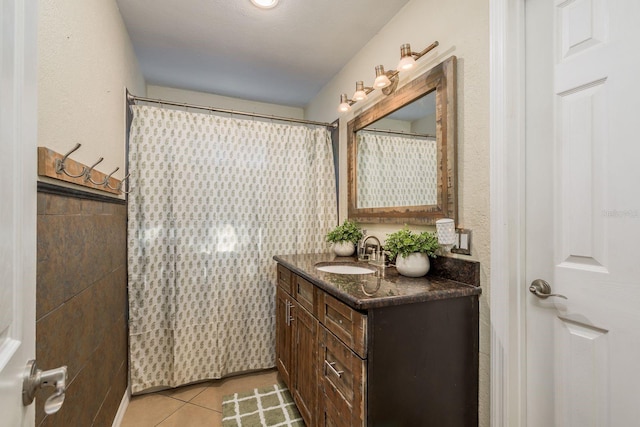 bathroom featuring tile patterned flooring and vanity