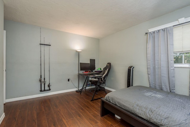 bedroom with dark hardwood / wood-style floors