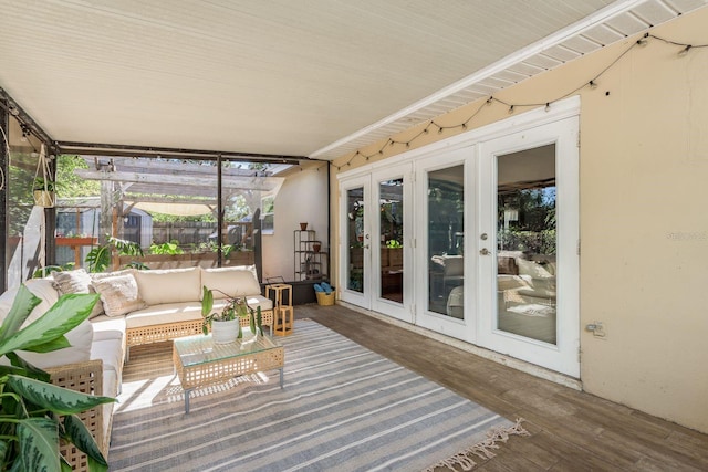 sunroom / solarium featuring french doors