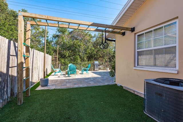 view of yard with a patio and central air condition unit