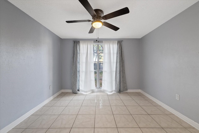 unfurnished room with light tile patterned floors and ceiling fan