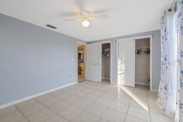 unfurnished bedroom with ceiling fan and light tile patterned floors