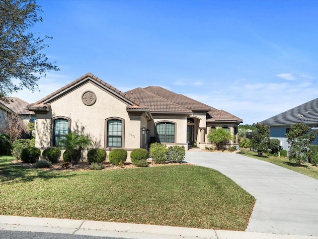 mediterranean / spanish-style house with a front yard