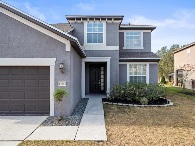 view of front of home featuring a garage and a front yard