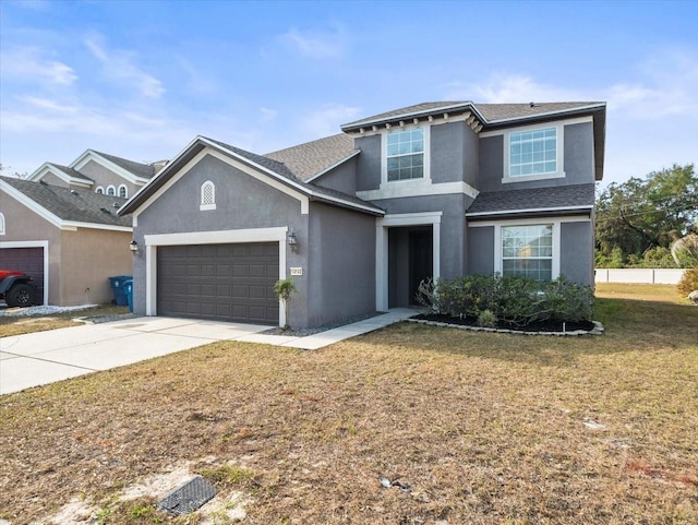 front facade featuring a garage and a front lawn