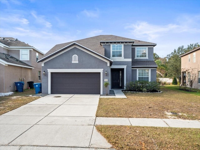 view of front property with a front yard and a garage