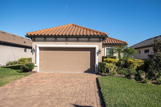 mediterranean / spanish home featuring a garage and a front lawn