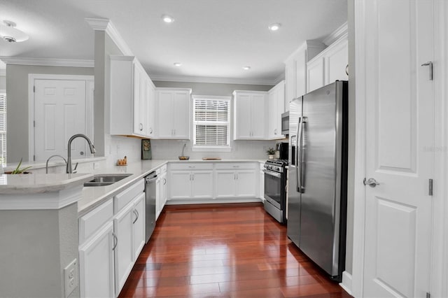 kitchen featuring backsplash, ornamental molding, stainless steel appliances, and white cabinets