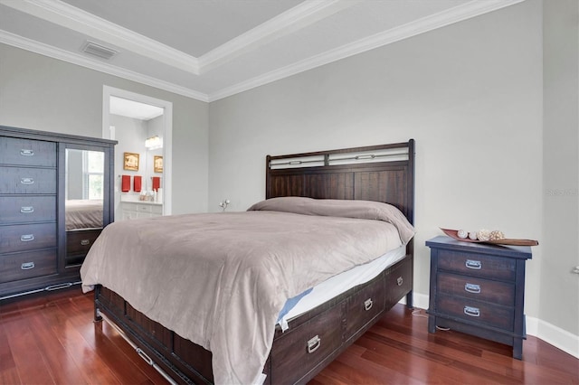 bedroom featuring visible vents, ensuite bathroom, crown molding, baseboards, and dark wood-style flooring