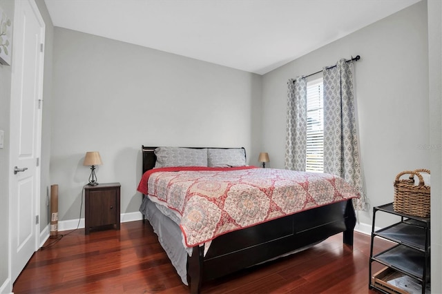 bedroom with baseboards and wood finished floors