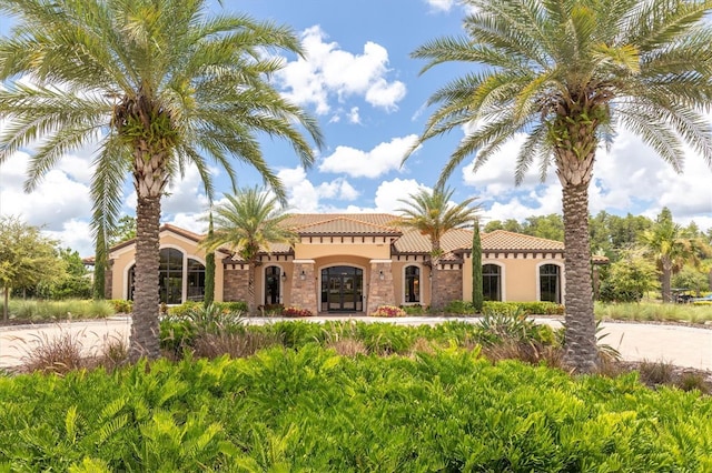 mediterranean / spanish home with stucco siding and a tiled roof
