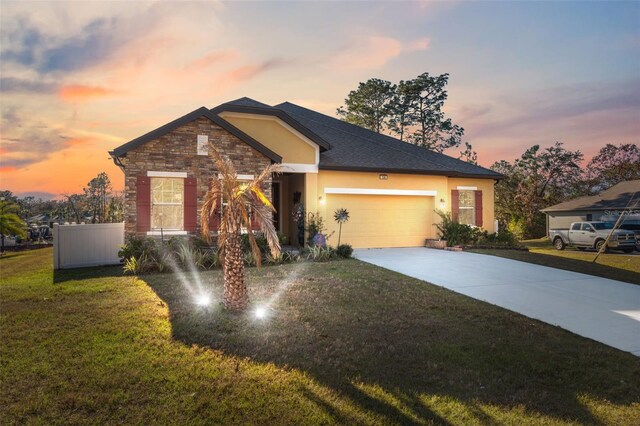 view of front of home with a lawn and a garage