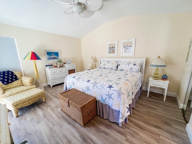 bedroom featuring ceiling fan, light hardwood / wood-style floors, and vaulted ceiling