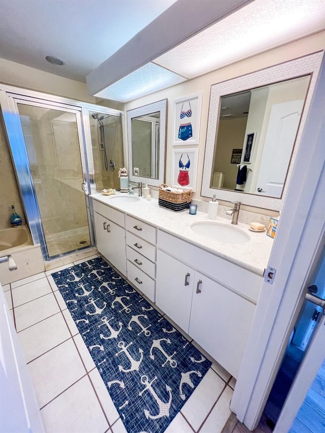 bathroom with tile patterned flooring, vanity, and a shower with door