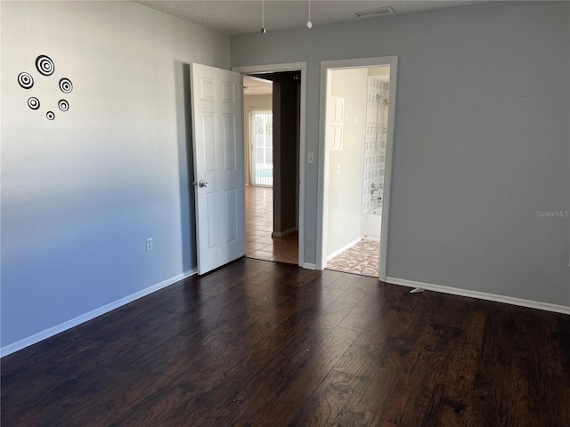 empty room featuring dark hardwood / wood-style flooring