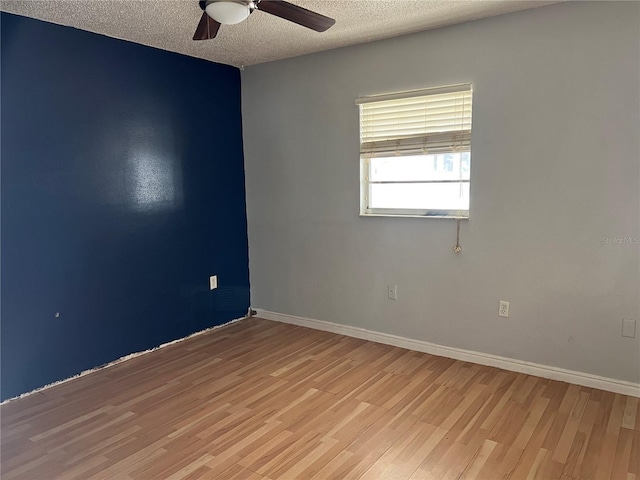 unfurnished room featuring a textured ceiling and light hardwood / wood-style flooring