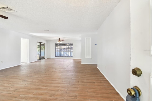 unfurnished living room featuring a textured ceiling and ceiling fan