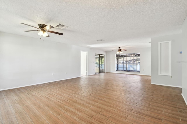 empty room featuring ceiling fan and a textured ceiling