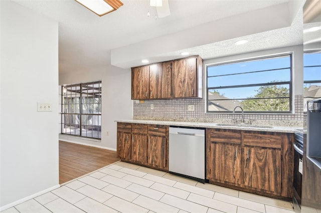 kitchen with backsplash, sink, stainless steel dishwasher, ceiling fan, and electric range