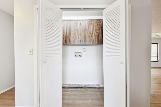 washroom featuring ceiling fan, hookup for a washing machine, and a textured ceiling