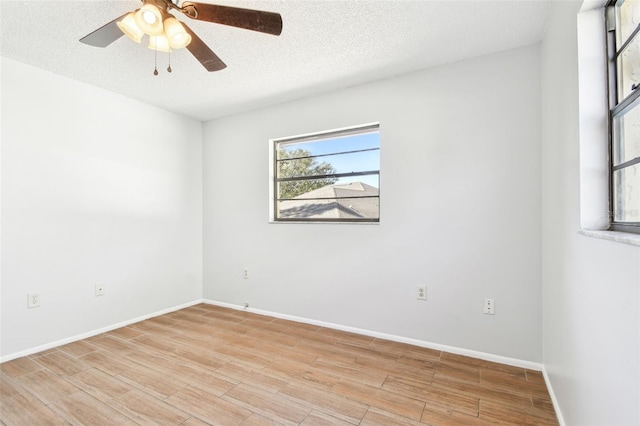 spare room with a textured ceiling and ceiling fan