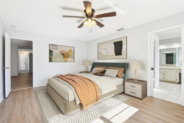 bedroom with ensuite bath and ceiling fan