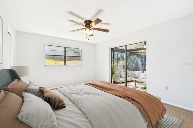 bedroom featuring access to exterior, ceiling fan, a textured ceiling, and hardwood / wood-style flooring