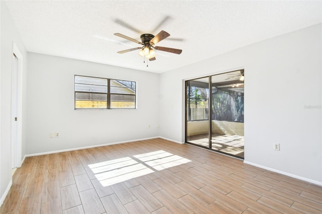 unfurnished room featuring ceiling fan and a textured ceiling