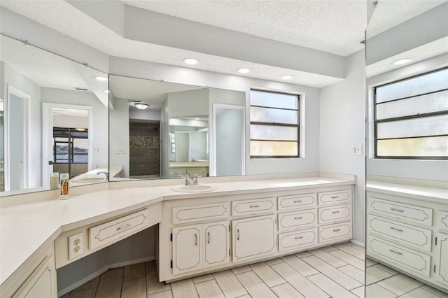 bathroom with vanity and a textured ceiling