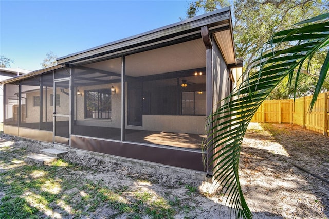 back of house featuring a sunroom