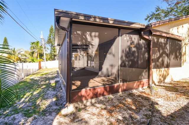 view of property exterior featuring a sunroom