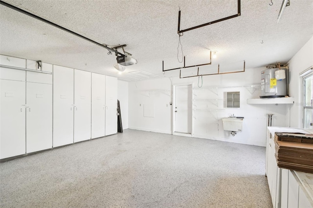 garage with electric water heater, sink, and a garage door opener