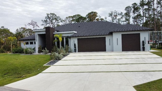 view of front of property featuring a garage and a front lawn