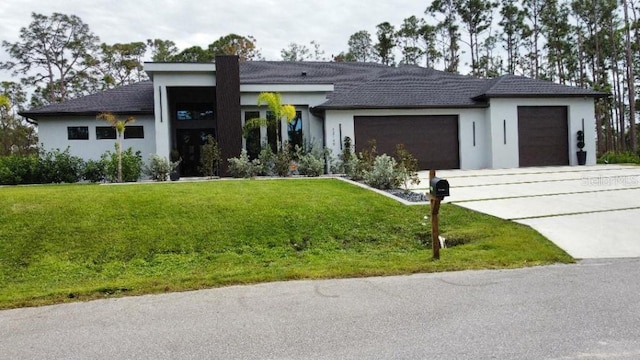 view of front of property featuring a garage and a front yard