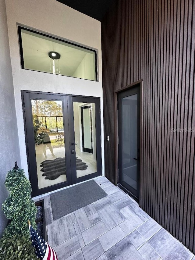 view of exterior entry featuring french doors