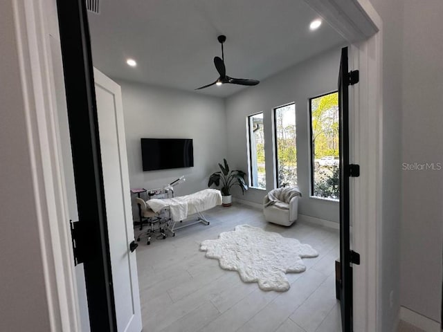 bedroom with ceiling fan and light hardwood / wood-style floors