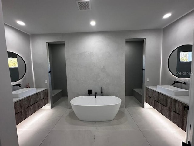 bathroom with vanity and a tub to relax in