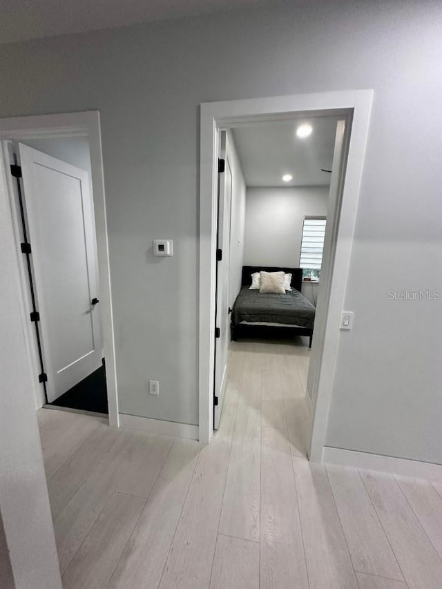 hallway with light hardwood / wood-style flooring