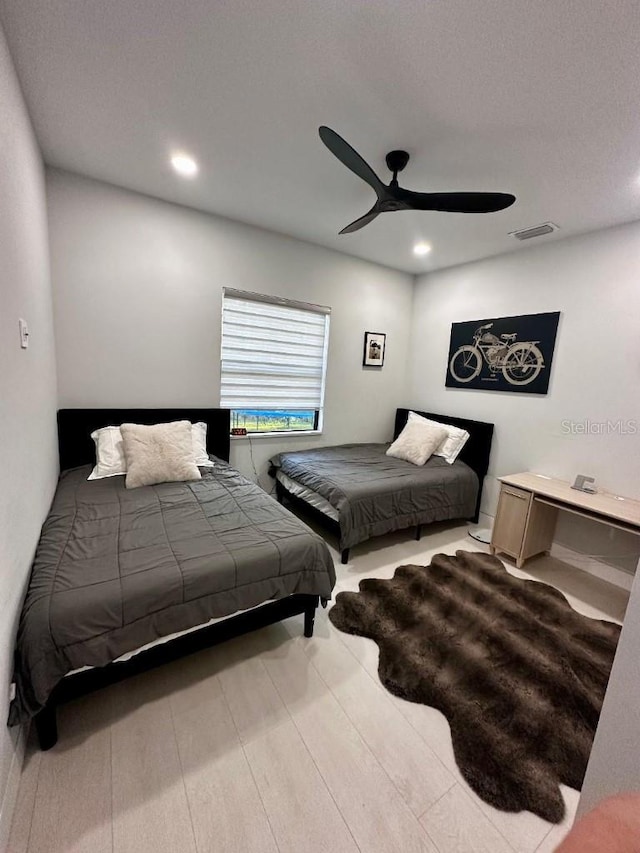 bedroom with light hardwood / wood-style floors and ceiling fan