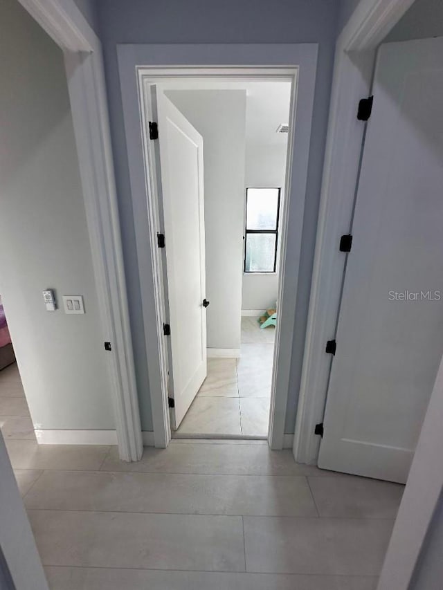 corridor with light tile patterned floors