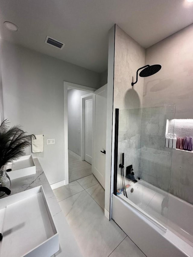 bathroom featuring vanity and tiled shower / bath