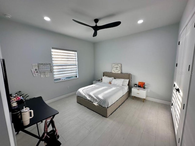 bedroom with light hardwood / wood-style floors and ceiling fan