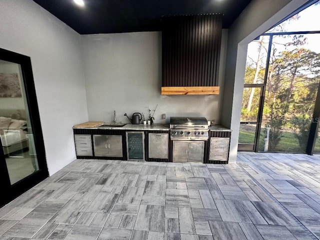 view of patio with glass enclosure, area for grilling, grilling area, and sink