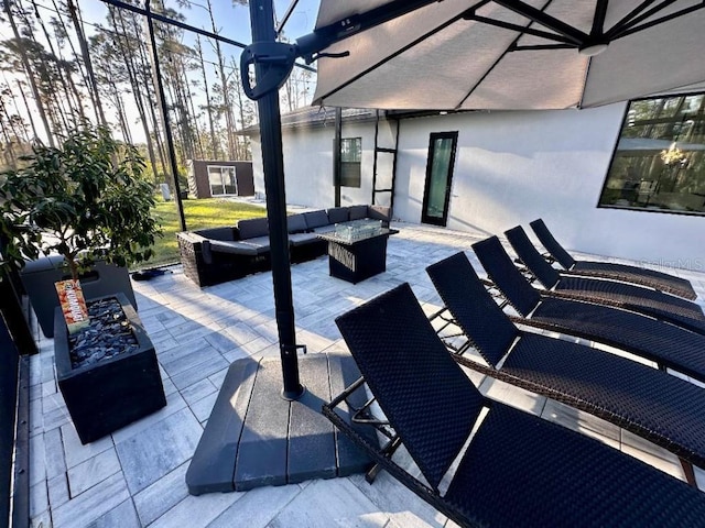 view of patio / terrace featuring an outdoor living space with a fire pit