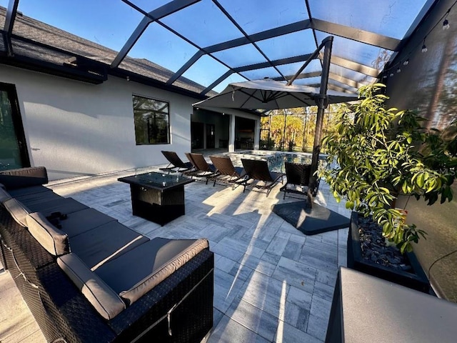 view of patio featuring a lanai and an outdoor living space with a fire pit