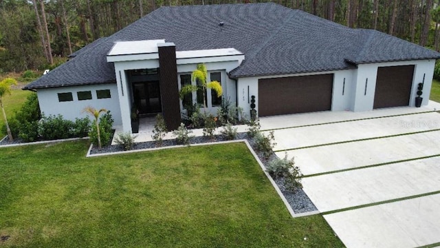 contemporary house with a front lawn and a garage